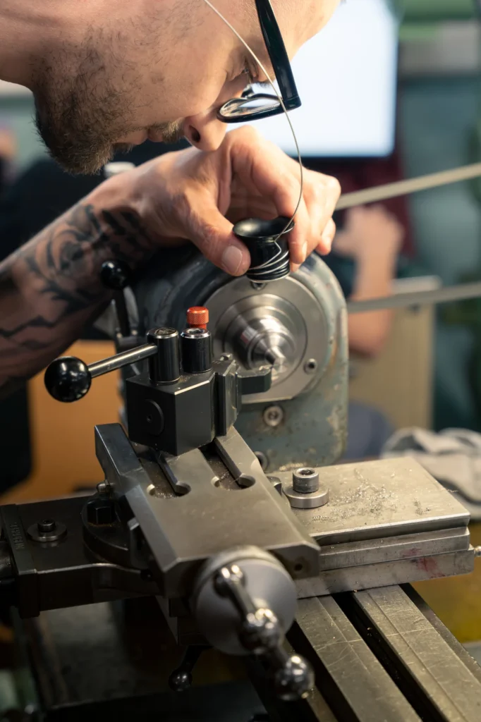 Watchmaker working on Lathe