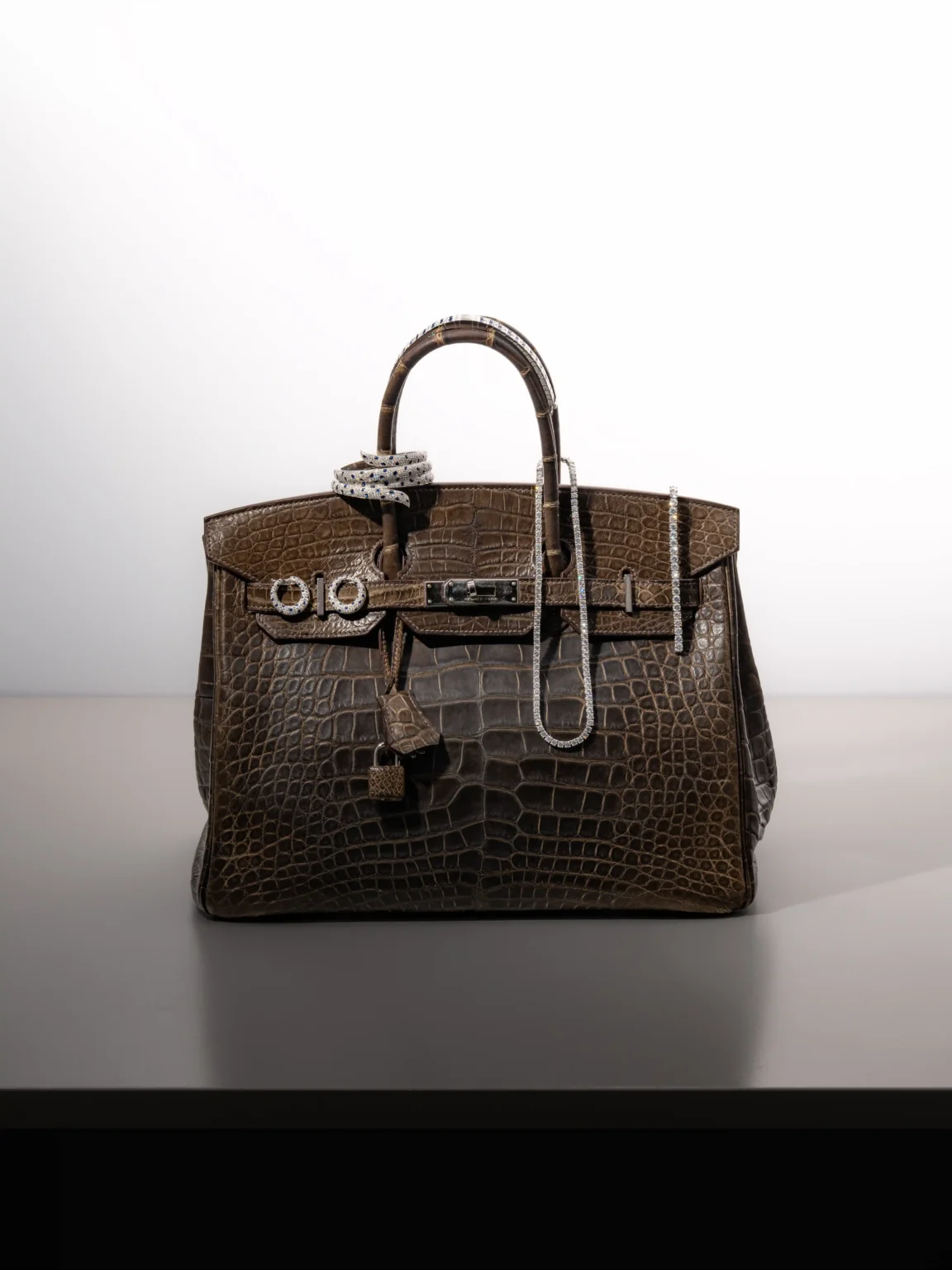 Cartier diamond jewellery with a brown crocodile Hermès Birkin bag